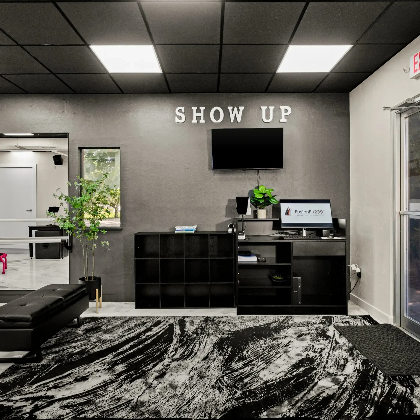 FusionFit239 front desk and lobby under the SHOW UP sign